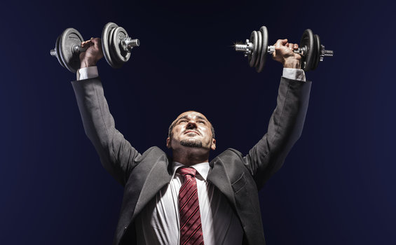 Business man lifting weights - What It Means for Businesses to be Lean